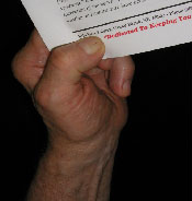 A person holding paper with their hand